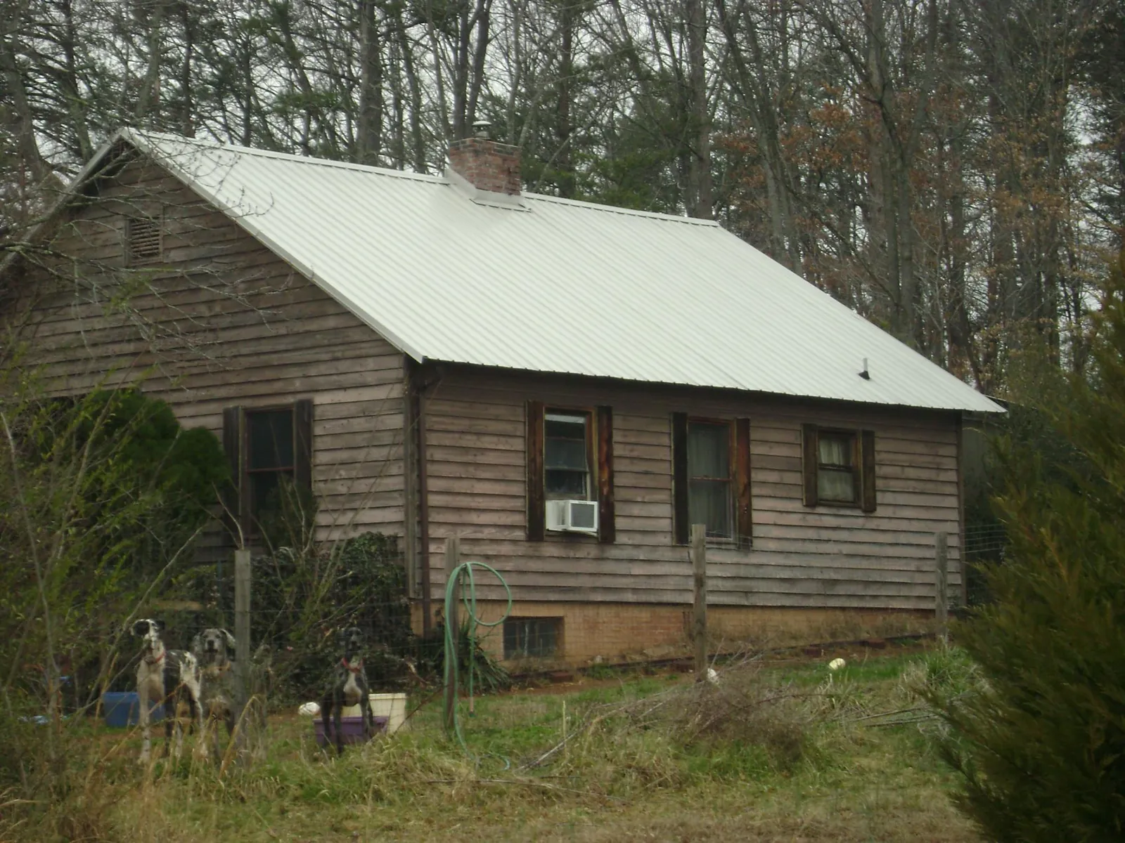 White metal roof on an old wood sided farmhouse, from a Metal Roof Installation job in Amboy